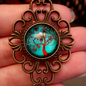 Victorian style bird necklace with tree of life cabochon, bird cage and bird, turquoise swarovski crystals silver filigree moon gold star and copper leaf. 