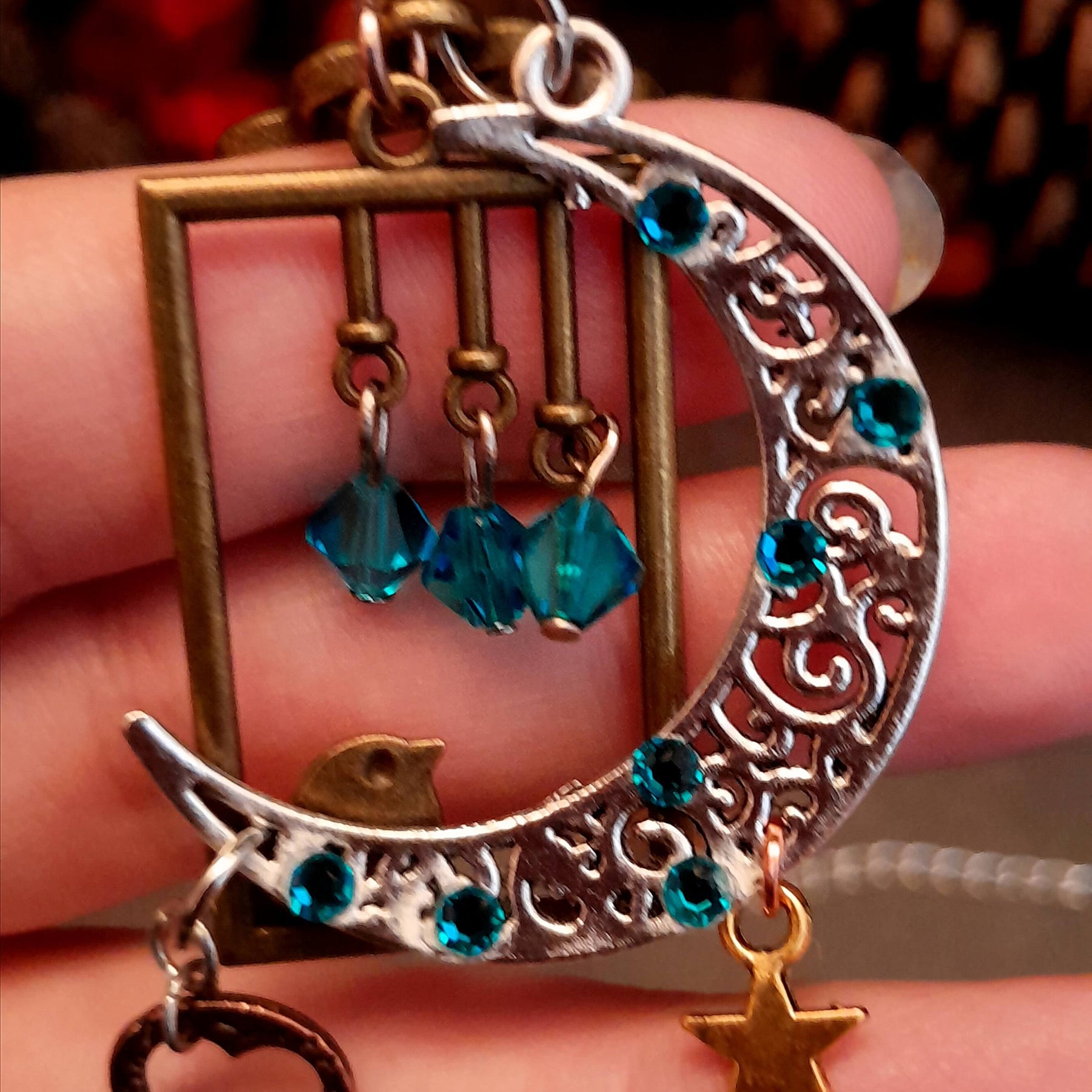 Victorian style bird necklace with tree of life cabochon, bird cage and bird, turquoise swarovski crystals silver filigree moon gold star and copper leaf. 