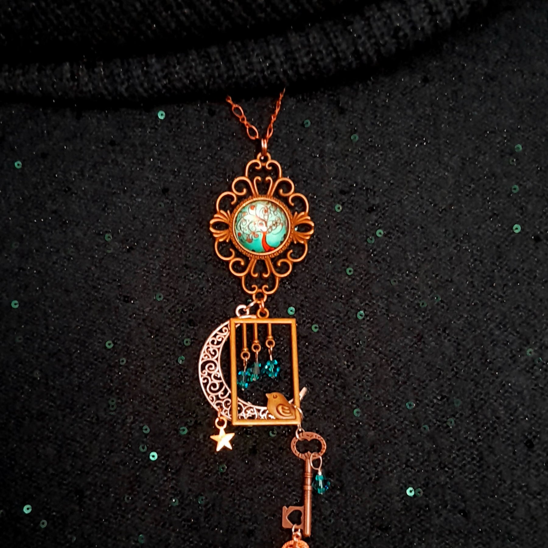 Victorian style bird necklace with tree of life cabochon, bird cage and bird, turquoise swarovski crystals silver filigree moon gold star and copper leaf. 