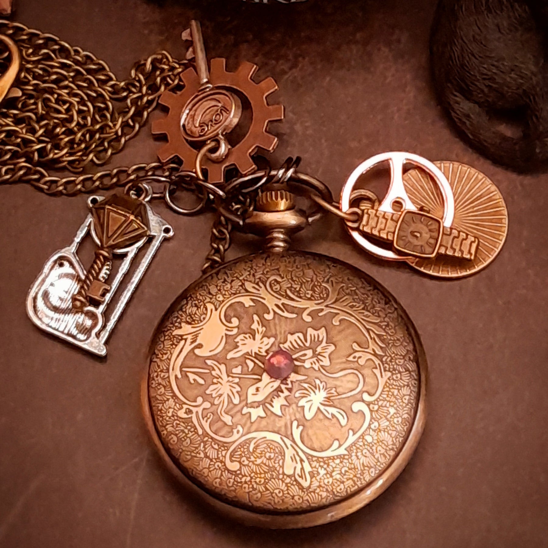 Victorian style clock necklace with dangling skeleton key charms and steampunk gear accents