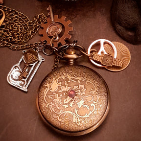 Victorian style clock necklace with dangling skeleton key charms and steampunk gear accents