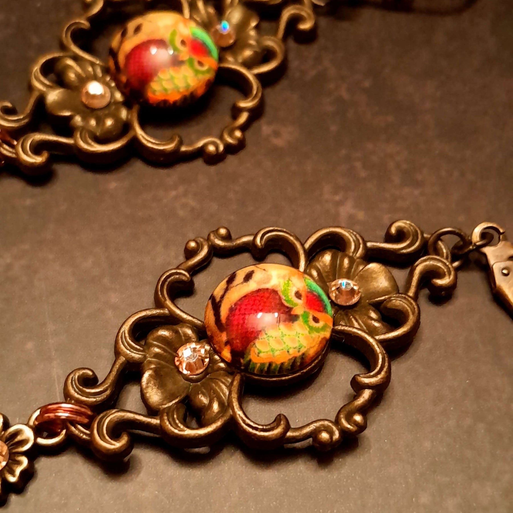 4 owl cabochons nesstled into victorian style brass settings. swarovski crystals