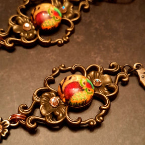 4 owl cabochons nesstled into victorian style brass settings. swarovski crystals