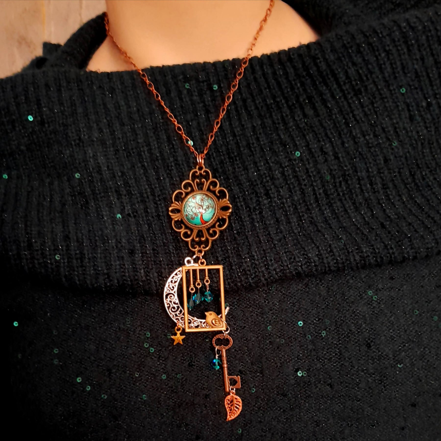 Victorian style bird necklace with tree of life cabochon, bird cage and bird, turquoise swarovski crystals silver filigree moon gold star and copper leaf. 