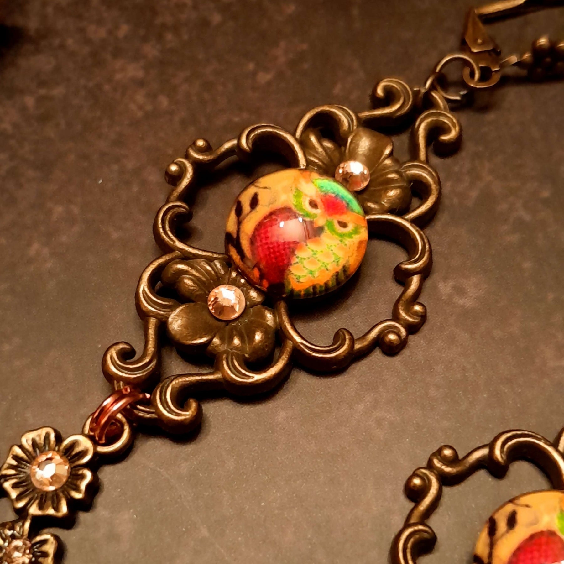 4 owl cabochons nesstled into victorian style brass settings. swarovski crystals
