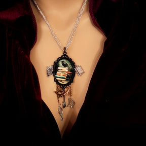 fairytale necklace with book mirror spinning wheel crest magic lamp witch hat broom and crow on books
