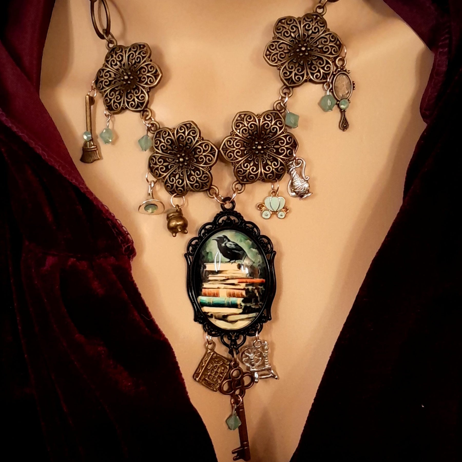 Full view of witchy black crow necklace with storybook charms and Swarovski crystals, Victorian style vintage style handmade jewelry, Rachel Flam Design