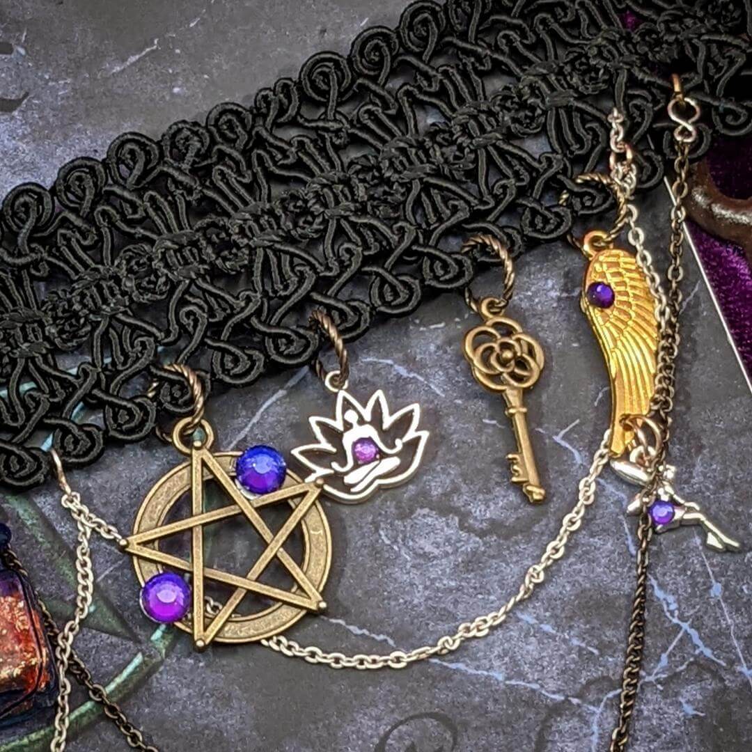 black choker charm closeup key pentagram chains