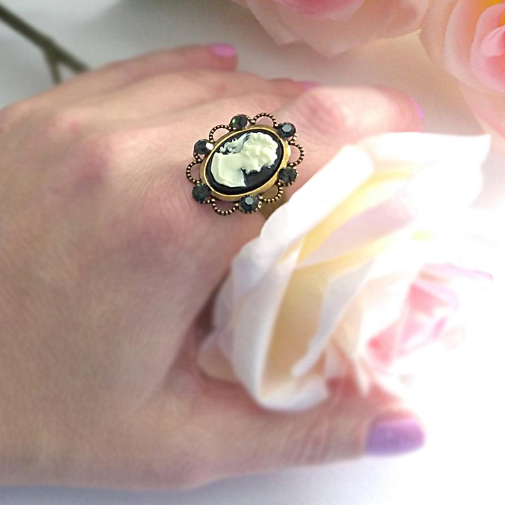 black lady victorian cameo ring on hand with white rose